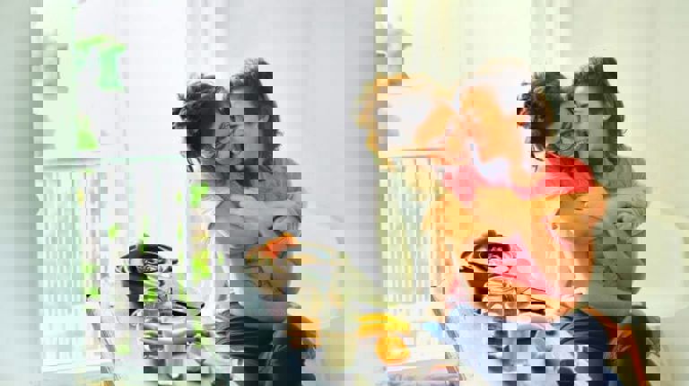 two women hugging each other at a breakfast table two women hugging each other at a breakfast table