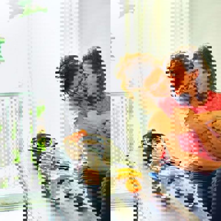 two women hugging each other at a breakfast table two women hugging each other at a breakfast table