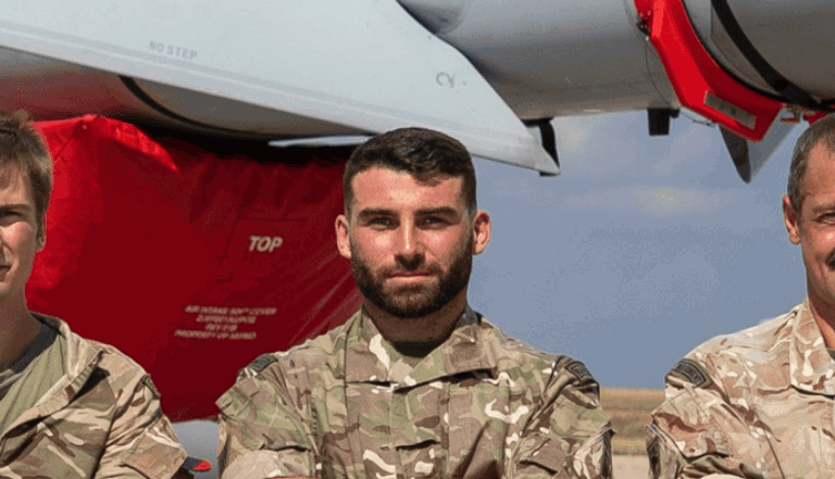 man in army uniform standing in front of a plane man in army uniform standing in front of a plane