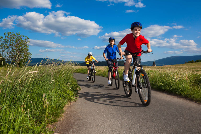 three children riding bicycles in outdoors three children riding bicycles in outdoors
