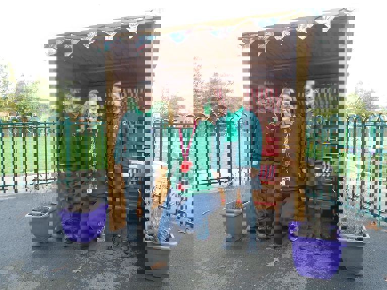 three children standing in a wooden shed three children standing in a wooden shed