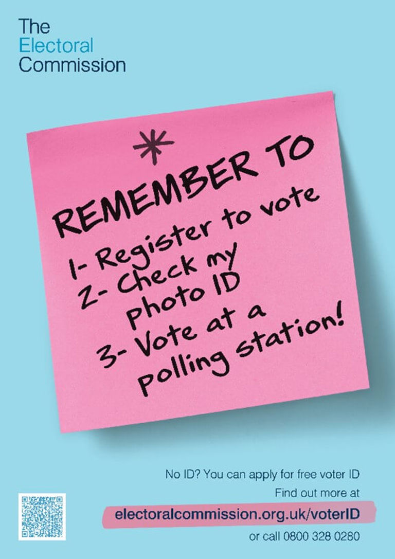 pink post it on blue background with remember to vote written in black marker pink post it on blue background with remember to vote written in black marker