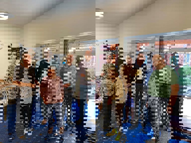 A group of people holding certificates for gardening awards A group of people holding certificates for gardening awards