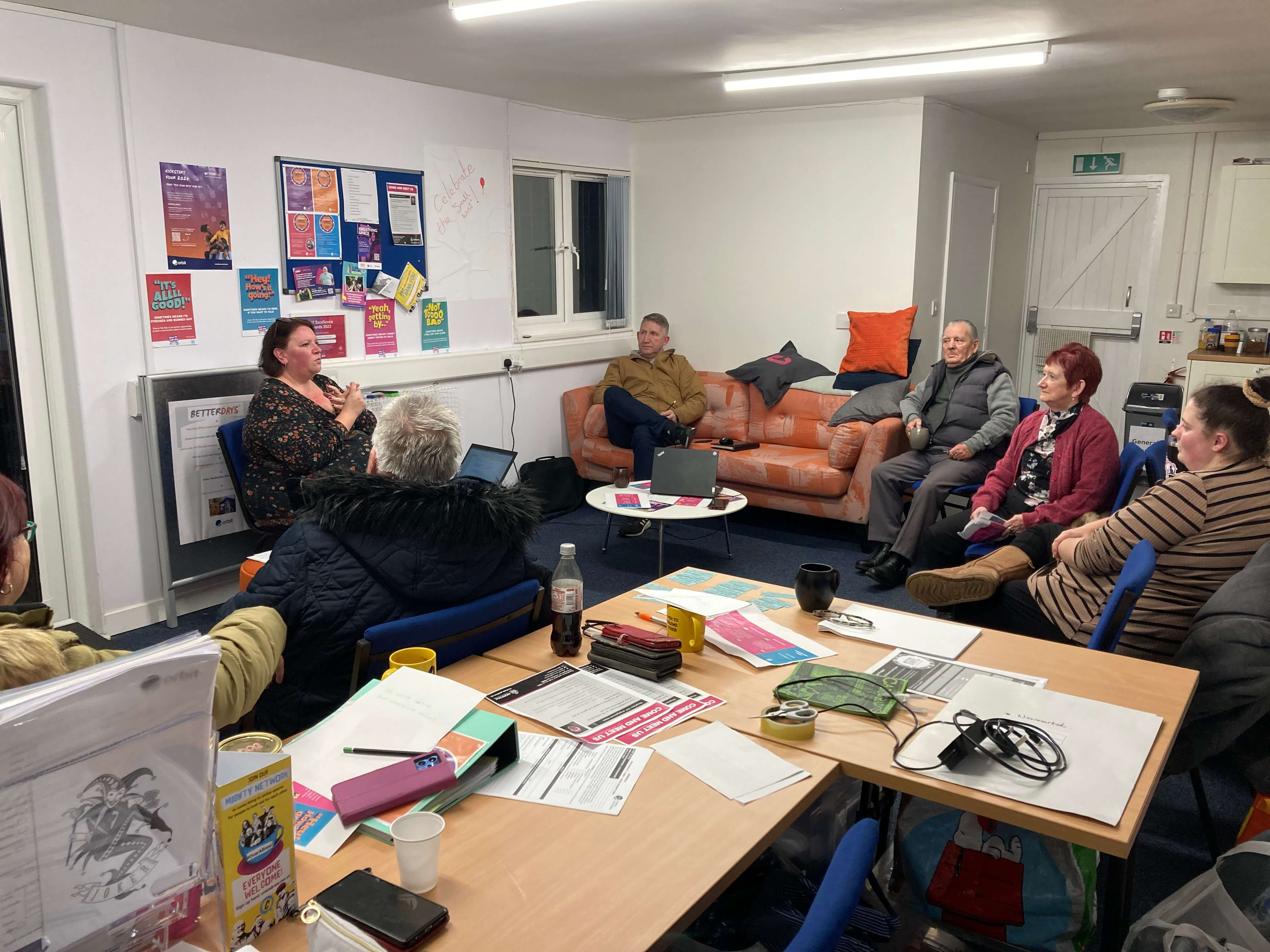 people sitting in a circle in a lounge talking