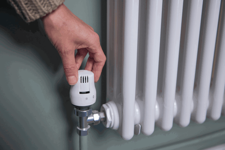 hand turning up temperature on a heater hand turning up temperature on a heater