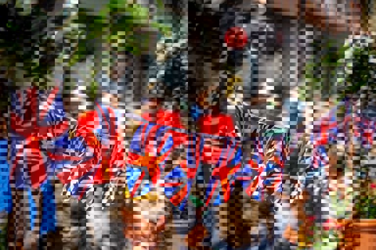 Union Jack flags strung across the street for the Kings coronation Union Jack flags strung across the street for the Kings coronation