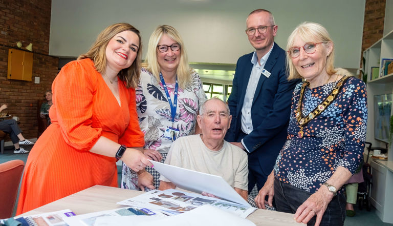 four people looking at designs four people looking at designs