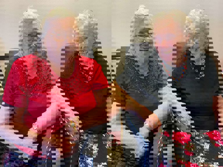 two older ladies sitting next to each other and smiling two older ladies sitting next to each other and smiling