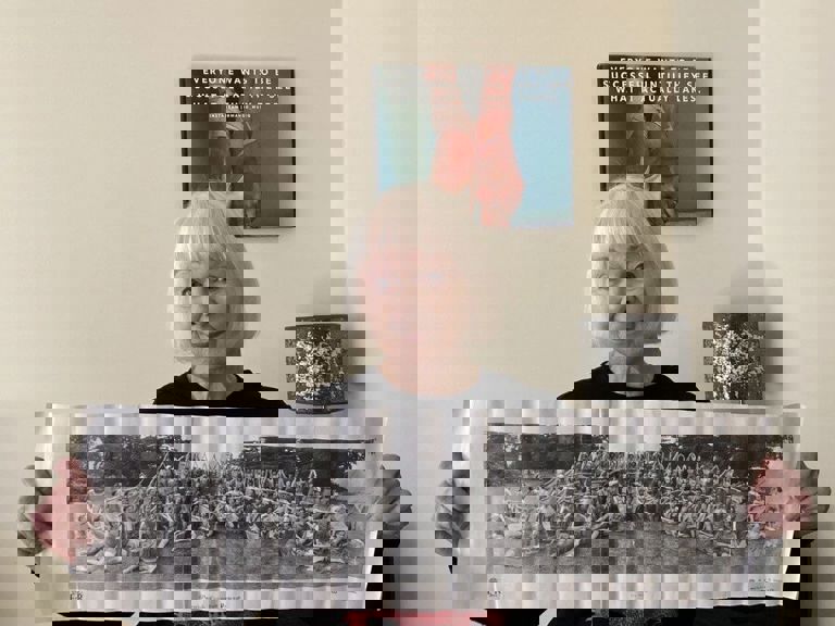 olivia holding up a page with a black and white image olivia holding up a page with a black and white image