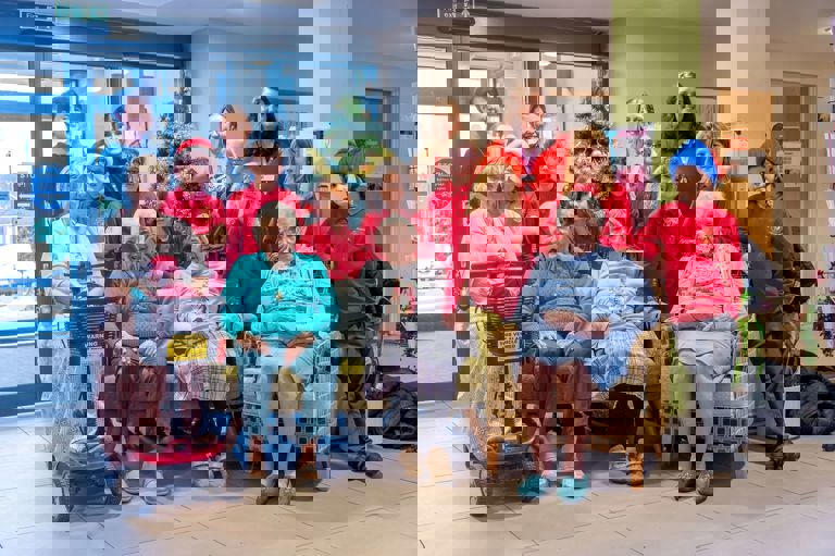 group of children from a choirs wearing red jerseys standing with older women group of children from a choirs wearing red jerseys standing with older women
