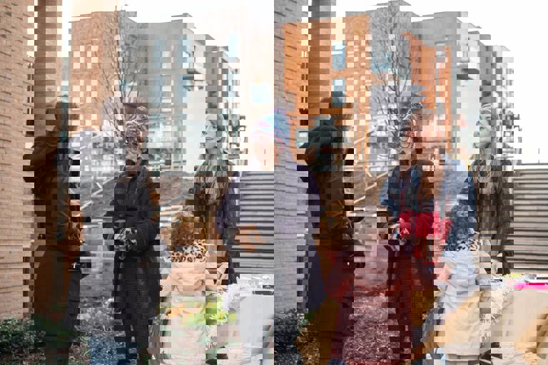 three ladies and a girl standing outside talking three ladies and a girl standing outside talking