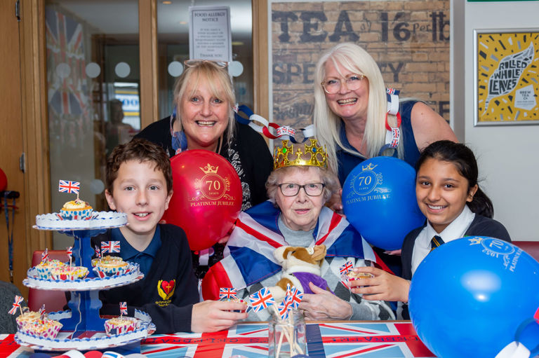group of ladies and kids sitting at a table with union jack cupcakes group of ladies and kids sitting at a table with union jack cupcakes