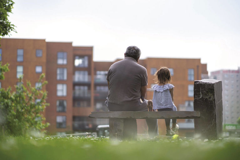 father and child sitting on a bench father and child sitting on a bench