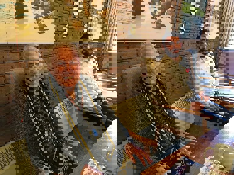 two men named John and David sitting in a lounge two men named John and David sitting in a lounge