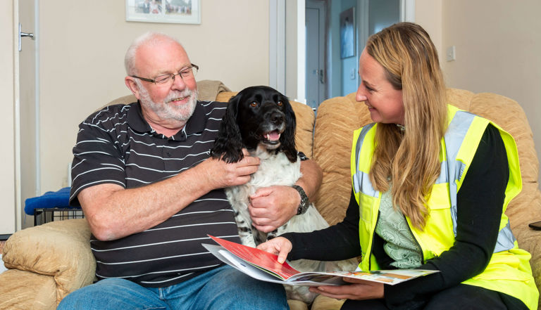 man sitting with his dog talking to a lady man sitting with his dog talking to a lady