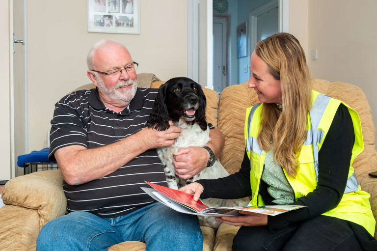 man sitting with his dog talking to a lady man sitting with his dog talking to a lady
